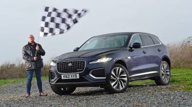 Stuart Milne waving chequered flag over Jaguar F-Pace